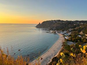 a view of a beach at sunset at B&B Capo Vaticano Stay in Capo Vaticano