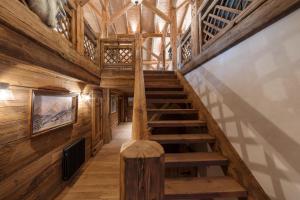 a staircase in a cabin with wooden walls and ceilings at La Ferme 1828 in Demi-Quartier