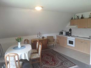 a kitchen with a table and chairs and a kitchen with a table and a counter at Ferienwohnung Ewen 55038 in Filsum