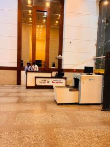 two people sitting at a desk in a building at THE CITYLIGHTS STAY Gaur City Mall in Ghaziabad