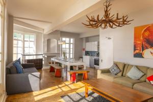 a living room with a couch and a table at Pier Court Apartments Brighton in Brighton & Hove