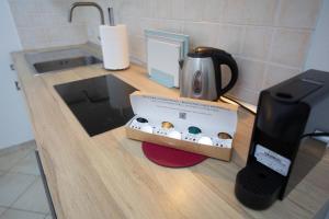a counter with a box of donuts and a coffee maker at Dimora del Murattiano in Monopoli