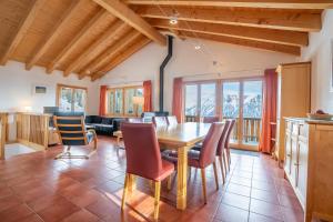 a kitchen and dining room with a table and chairs at Chalet UVA in Bettmeralp