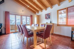 a dining room with a wooden table and chairs at Chalet UVA in Bettmeralp +24 photos