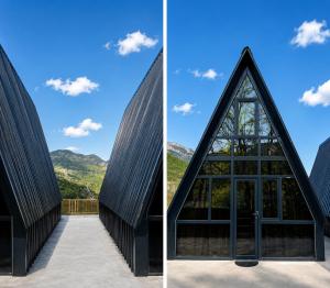 a church with a triangular roof and a glass door at Chalet Adjara in Okʼropilauri