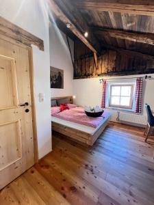 a bedroom with a bed and a wooden floor at Haus Edelweiss Alpine Chalet near Samnaun in Spiss