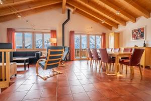 a dining room with a table and chairs at Chalet UVA in Bettmeralp