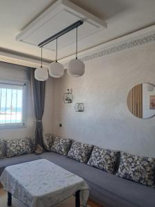 a living room with a couch and a table at Appartement à m'diq in M'diq