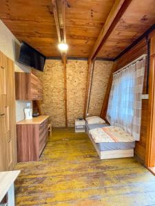 a bedroom with a bed in a room with wooden ceilings at Przygoda nad Wartą in Burzenin