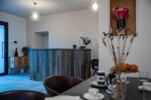 a dining room with a table with chairs and a wooden wall at Bastian B&B in Sarmede