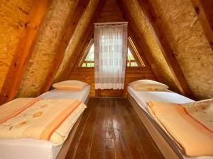 a room with two beds in a attic at Przygoda nad Wartą in Burzenin