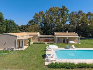a house with a swimming pool in a yard at Villa Botanica in Kassiopi