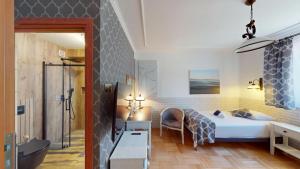 a bedroom with a bed and a bathroom at Śnieżka in Krosno +74 photos