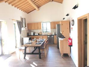 a kitchen with a wooden table and a kitchen with a tableablish at CasaBelaVista II in Pedreira