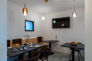a dining room with two tables and a tv at Bastian B&B in Sarmede