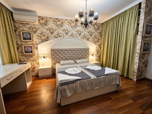a bedroom with a bed and a desk in it at Europroperties Zlatna Kotva Apartments in Golden Sands +156 photos