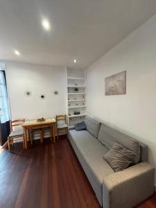 a living room with a couch and a table at Apartamento Manuel Cue en el centro de Llanes in Llanes
