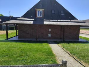 a red brick house with a black roof at AFASEC Résidence in Marolles-en-Brie