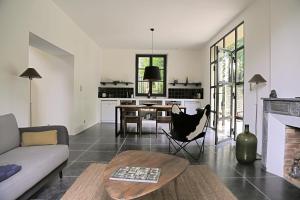 a living room with a couch and a table at Le Pavillon Du Regisseur in Val-de-Dagne