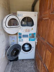 a washing machine and a toilet in a room at AFASEC Résidence in Marolles-en-Brie