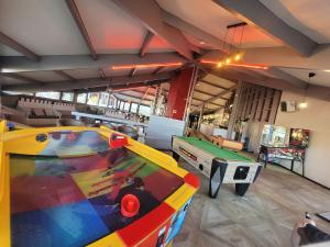 a large room with a pool table and a pool table at Mobil-home MJ in Seignosse