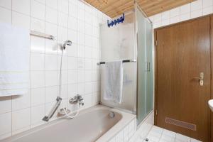 a bathroom with a bath tub and a shower at Ferienwohnung Vogel in Wertach