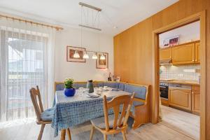 a kitchen and dining room with a table and chairs at Ferienwohnung Vogel in Wertach