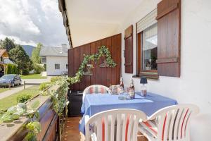 a table with a blue table cloth on a patio at Ferienwohnung Vogel in Wertach +17 photos