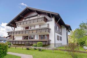a large white building with wooden balconies on it at Ferienwohnung Vogel in Wertach