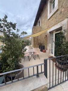 a patio with a table and chairs on a building at Val D'Orcia Panoramic Suite in Montalcino +2 photos