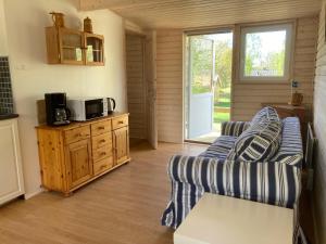 a living room with a couch and a microwave at Röksvamp 1 in Västra Stensjö