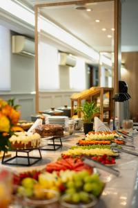 a buffet line with many different types of food at Biazi Plaza Hotel Bauru in Bauru +30 photos