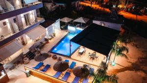 an overhead view of a swimming pool with chairs and umbrellas at Zogaj Hotel in Ksamil +269 photos