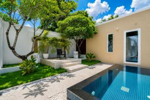 a swimming pool in the backyard of a house at Sunshine Beach Villa Mai Khao in Mai Khao Beach