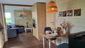 a kitchen and living room with a table in a room at Bungalow am Wald in Coswig