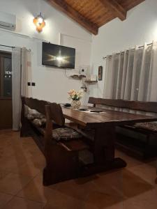 a dining room with a wooden table and a tv on the wall at Holiday Home Izabela in Kršan