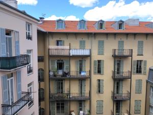 an apartment building with balconies in a city at Chez Brigitte Guesthouse in Nice