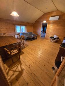an attic room with a pool table and wooden floors at Mara Ház in Lengyel
