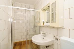 a white bathroom with a sink and a mirror at House Goran in Crikvenica +36 photos