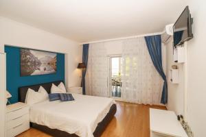 a bedroom with a bed and a tv in it at House Goran in Crikvenica
