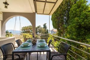 a blue table and chairs on a balcony at House Goran in Crikvenica