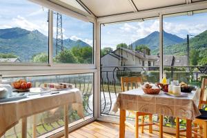 a dining room with a view of the mountains at Chambres d'Emilie - Table d'Hôte in Lau-Balagnas