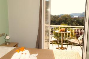 a room with a bed and a balcony with a view at Oliva Resort View & Swimming pool Studios in Parga +33 photos