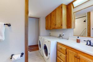 a kitchen with a washing machine and a sink at Whidbey Moon Landing in Coupeville