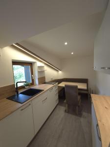 a kitchen with a sink and a counter top at Ferienwohnung Holiday Lienz in Lienz