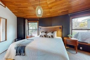 a bedroom with a large bed and a wooden ceiling at Whidbey Moon Landing in Coupeville
