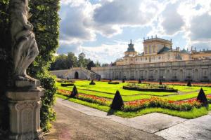 a large building with a garden in front of it at Lumina I Spacious 3BR Apartment with Parking I Balcony I Warszawa Zachodnia in Warsaw