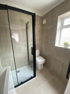 a bathroom with a shower and a toilet at Home in Greatstone in Greatstone +11 photos