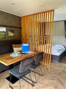 a room with a table with a laptop on it at EuroParcs Ossiacher See in Ossiach