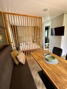a living room with a wooden table and a couch at EuroParcs Ossiacher See in Ossiach